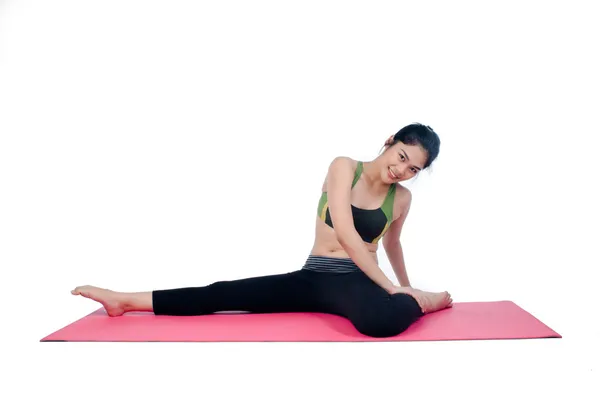 Beautiful woman indoor exercising using pink yoga mat — Stock Photo, Image