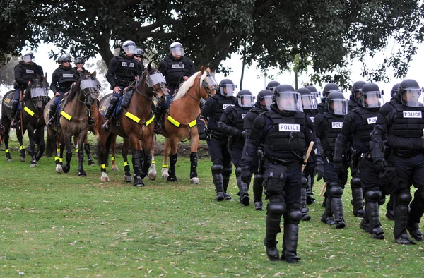 Modern day gladiators - police officers in riot gear respond to the civil disturbance — Stock Photo, Image