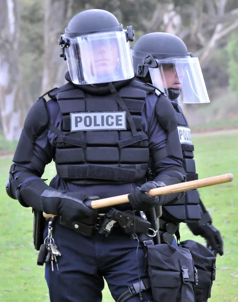 Show of force - police in riot gear move toward the civil unrest — Stock Photo, Image