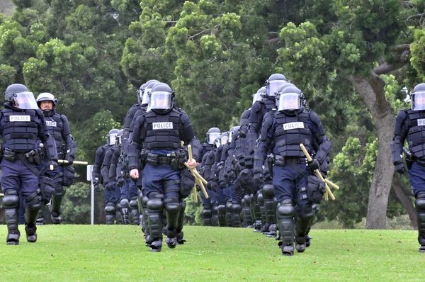 Moving toward the riot - police officers in protective gear — Stock Photo, Image