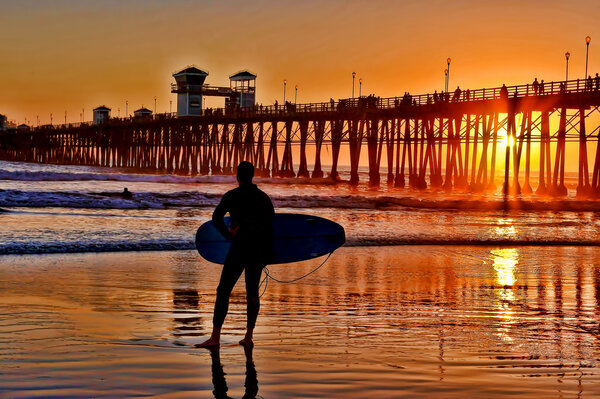 depositphotos_13878613-stock-photo-a-silhouetted-surfer-waits-for.jpg