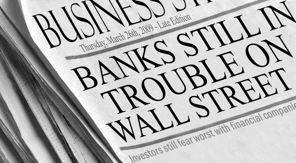 Newspaper headlines read \'Banks Still in Trouble On Wall Street\'