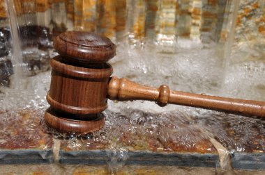 Wooden Gavel and flowing water clipart
