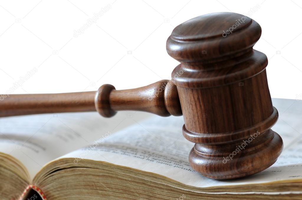 Gavel and legal book over white