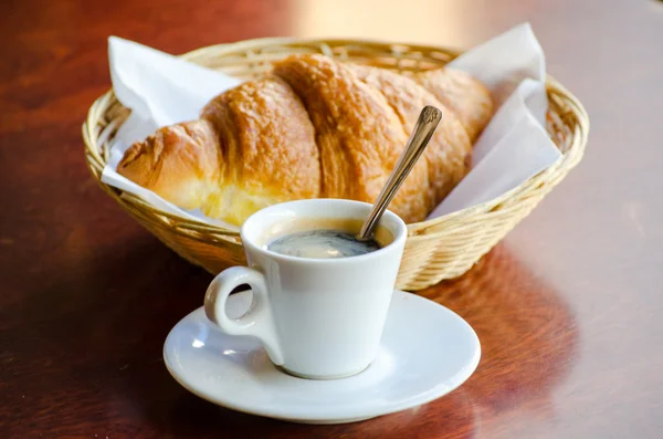 Cup of espresso with croissant — Stock Photo, Image