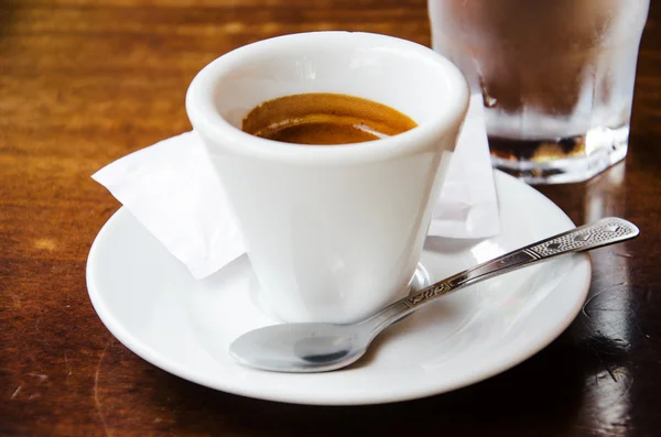 White espresso cup with glass of cold water — Stock Photo, Image