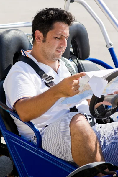 El hombre con el mapa en la mano se sienta en buggy — Foto de Stock