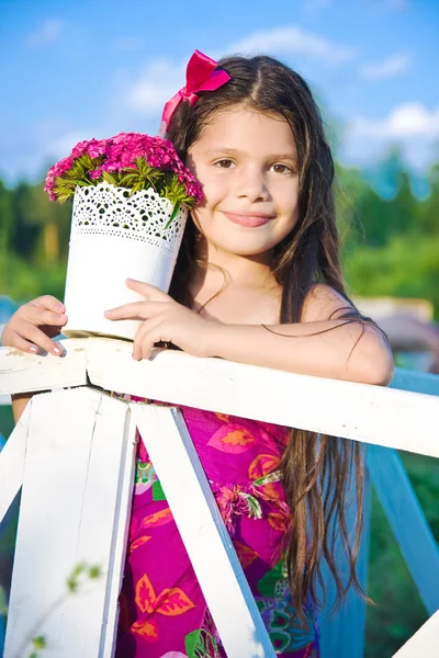 Girl with pink flowers in summer — Stock Photo, Image