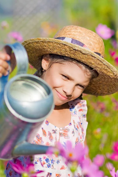 Girl posing with metal watering can shows thumb up — Stock Photo, Image