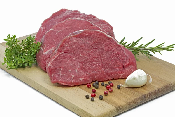 Beef fillet on a wooden plate — Stock Photo, Image