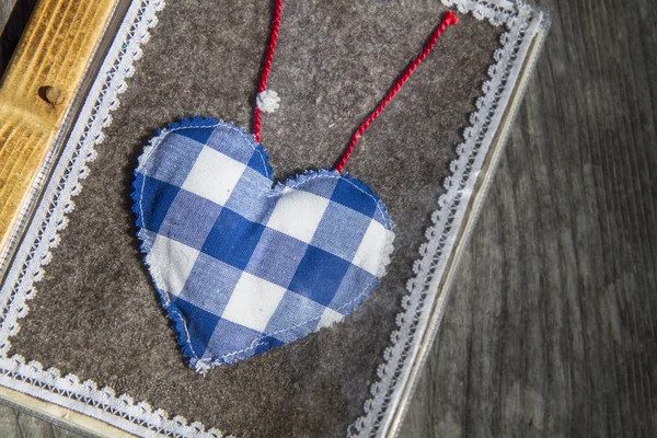Small handmade heart on grey felt — Stock Photo, Image