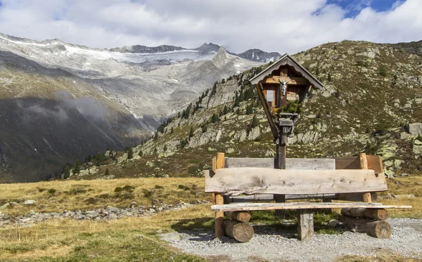 Wayside shrine and bench in the mountains