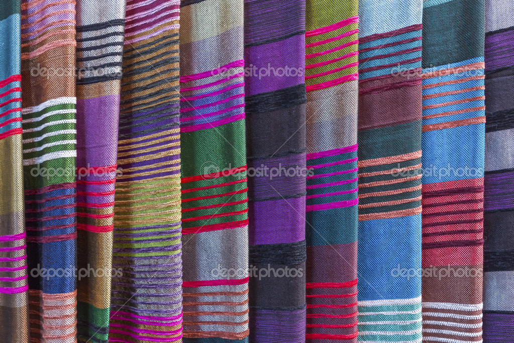 Colorful fabrics for sale on a market in Morocco — Stock Photo © haraldmuc 40362157