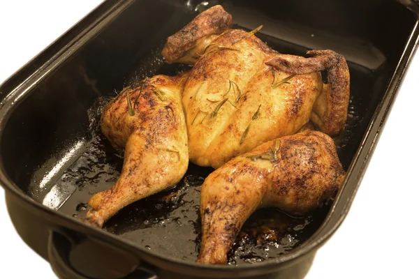 Flat roasted whole chicken in a roaster — Stock Photo, Image