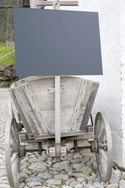 Old farm cart with information panel — Stock Photo, Image