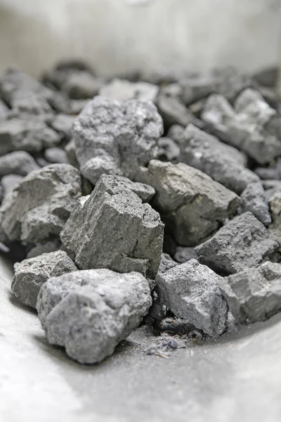 Grey pieces of coke on a shovel — Stock Photo, Image