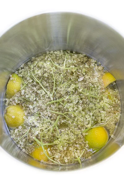 Elderflower, lemon and water in a pot — Stock Photo, Image
