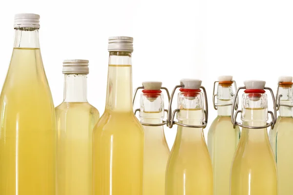 Bottles filled with elderflower syrup — Stock Photo, Image