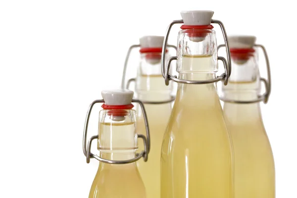 Bottles filled with elderflower syrup, shallow DOF — Stock Photo, Image