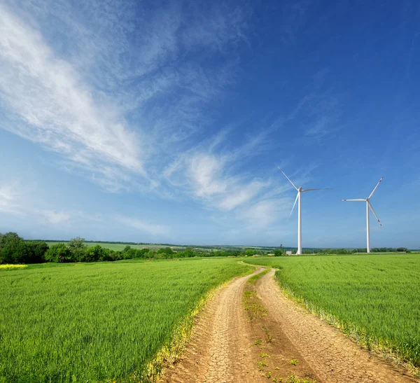 Wind turbines on a beautiful spring field — Stock Photo, Image