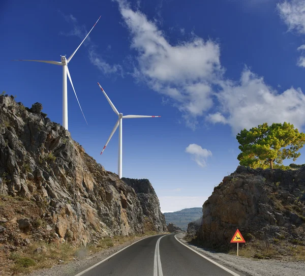 The road, windmills and mountains — Stock Photo, Image