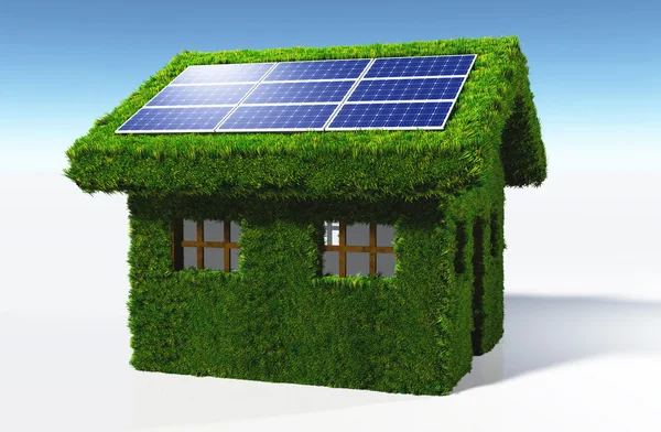 Met gras begroeide huis met zonnepanelen — Stockfoto