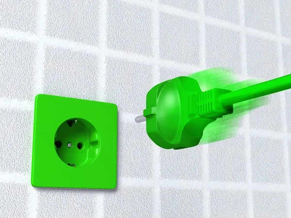 Gröna kontakten går in i ett uttag — Stockfoto