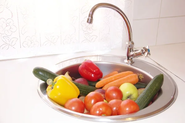 Limpiar las verduras en un fregadero — Foto de Stock