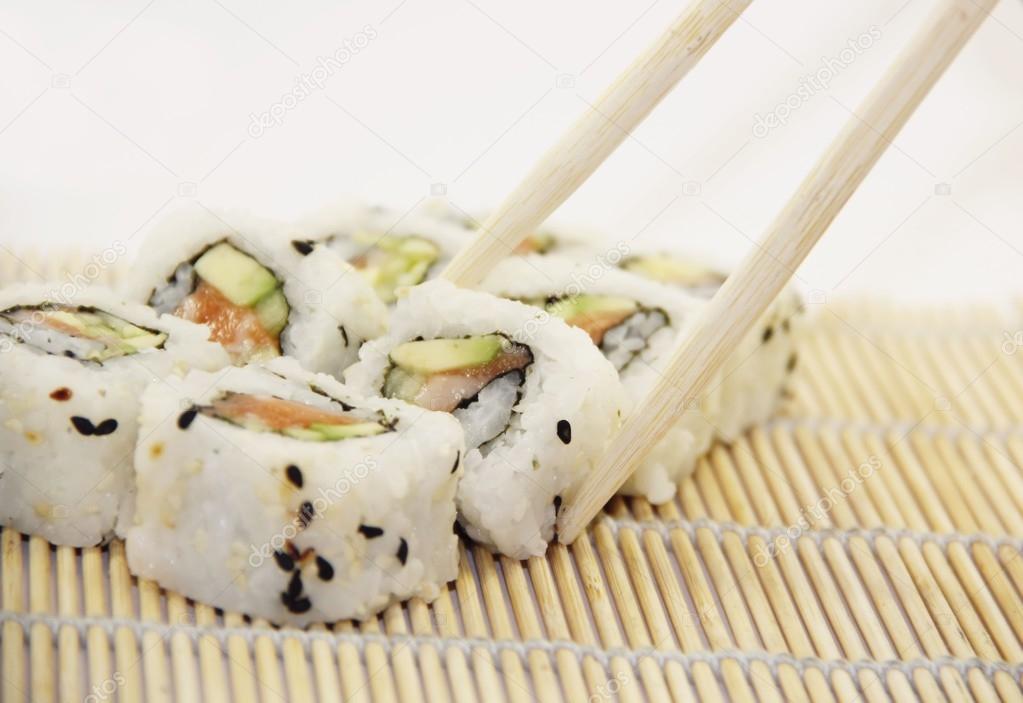 Sushi - California rolls with salmon on white background