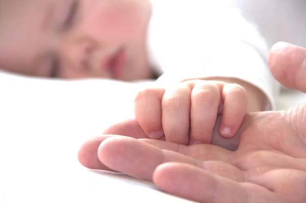 Sleeping child is holding hand of his father — Stock Photo, Image