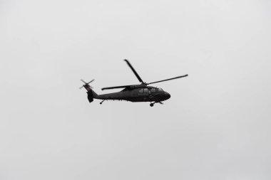 police black hawk helicopter flying over crow during colombian independence military parade day