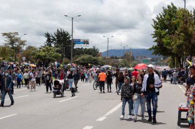 People walks in middle of Boyac avenue during Colombian Independence day Armed Forces parade.
