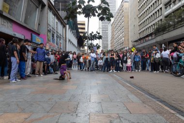 Young girl performing street break dance on 7th downtown street