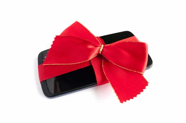 智能手机带着弓孤立和红丝带Smart telefon med rött band och rosett isolerade — 图库照片
