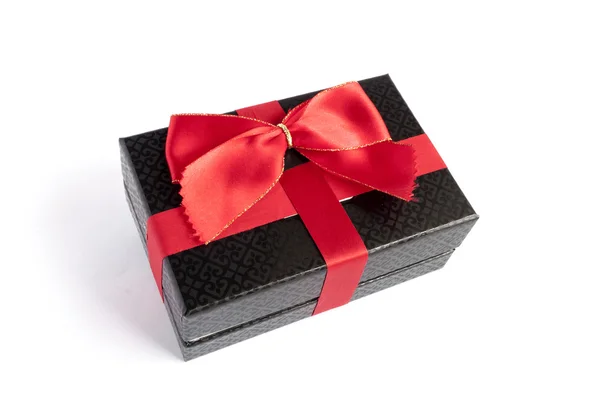 Single black gift box with red ribbon — Stock Photo, Image
