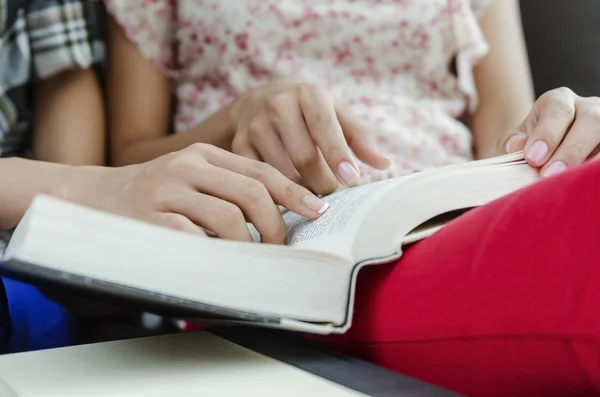 Closeup of human hand reading — Stock Photo, Image