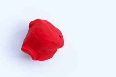 Beyaz arkaplanda kırmızı plastik kil.