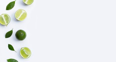 Beyaz arka planda yeşil yapraklı taze limonlar. Üst görünüm