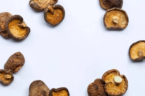 Dried shiitake mushrooms on white background.