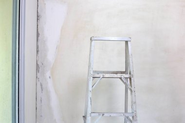 Duvarı boyamadan önce, alüminyum merdiven. Ev onarımı