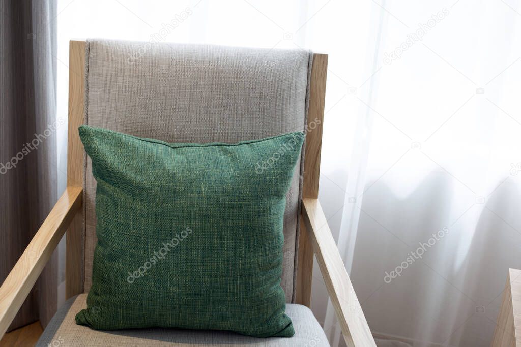 Green pillows in  chair,  Curtains background