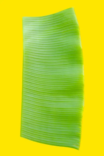 Banana leaf on yellow background