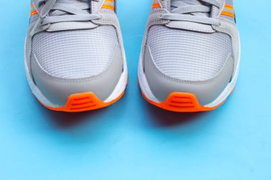 Mavi arka planda spor ayakkabıları.