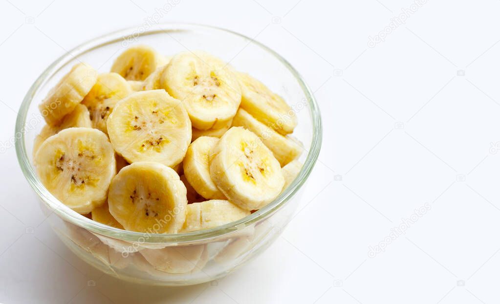 Banana slices in glass bowl on white background.