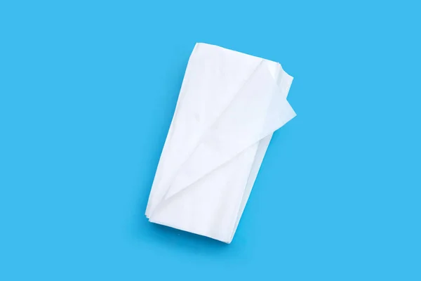Facial tissue on blue background.