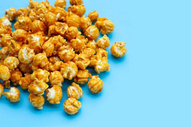 Honey caramel popcorn on white background.