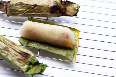 Grilled sticky rice in banana leaves with banana filling