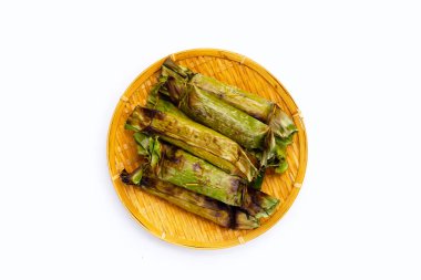 Grilled sticky rice in banana leaves with banana filling