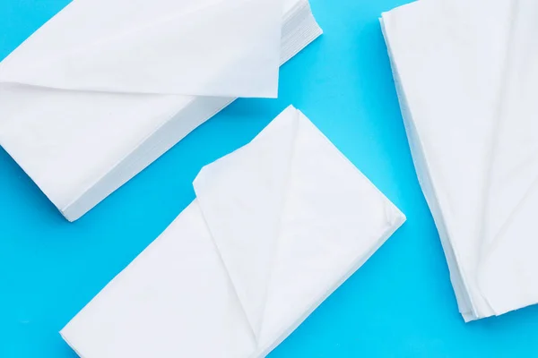 Facial tissue on blue background.