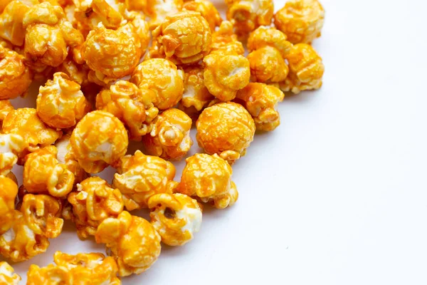 Honey caramel popcorn on white background.